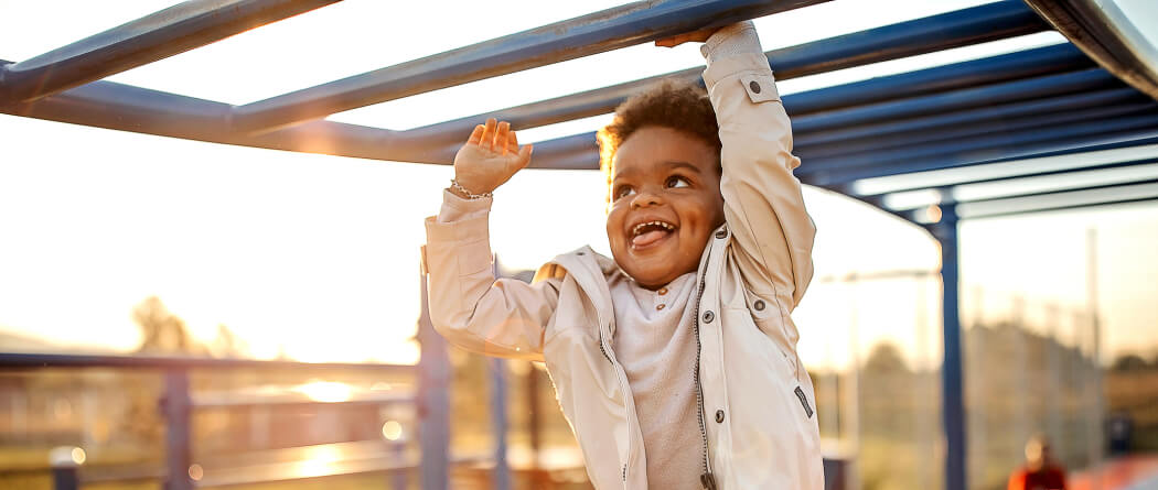 Young kid on monkey bars