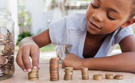 Young boy arranging change into stacks