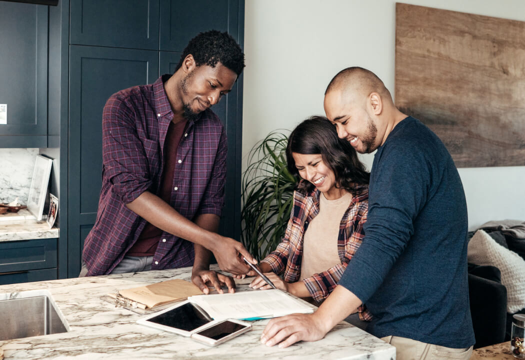 Couple standing in a kitchen with a contractor