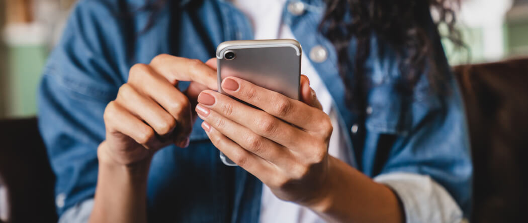 Close up of a person's hands using a smartphone